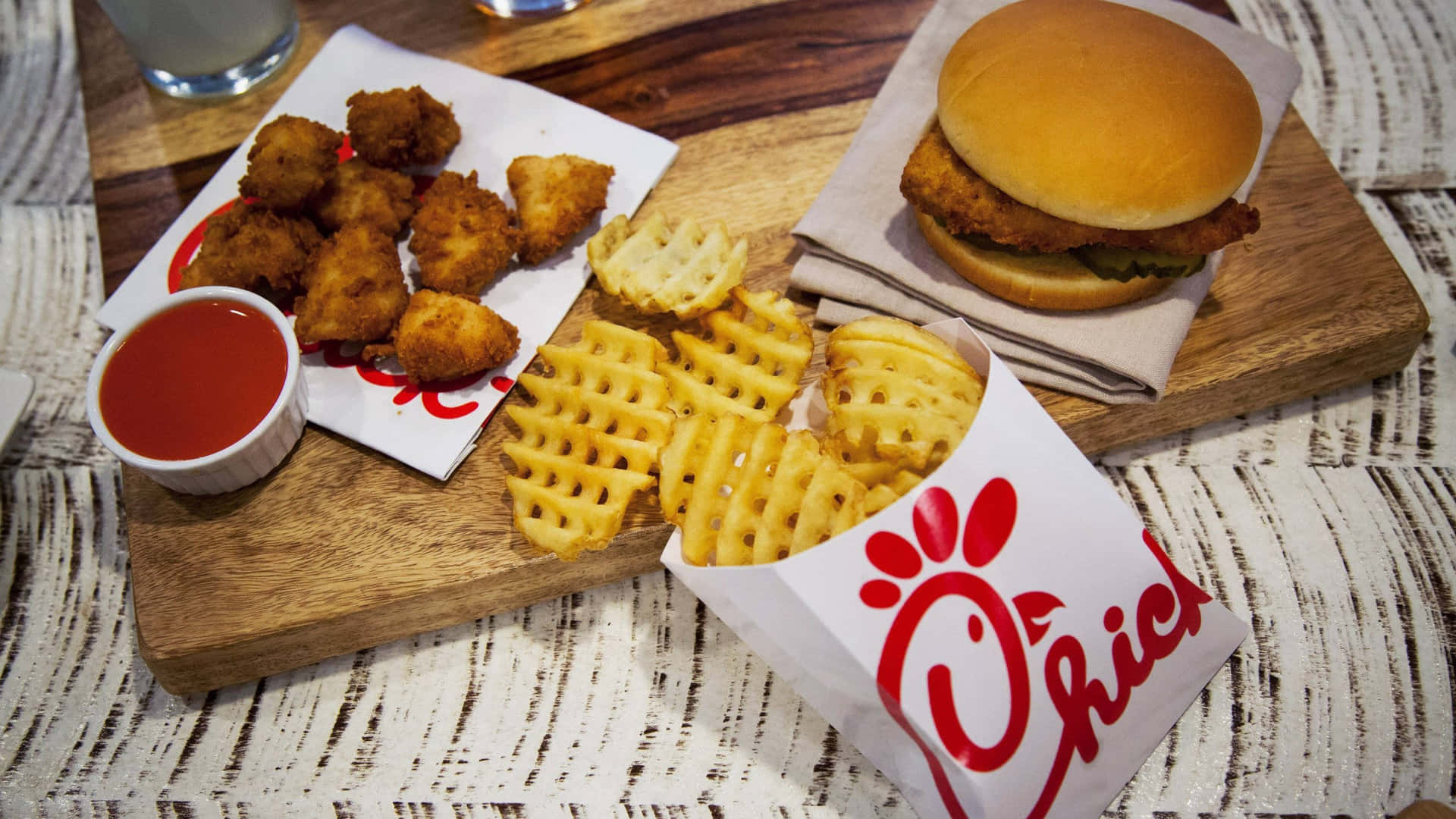 Chick-fil-a Burger And Fries On A Wooden Cutting Board
