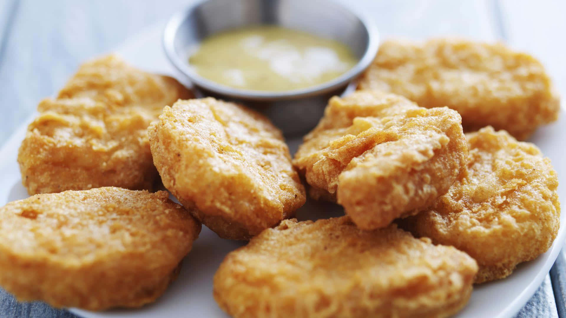 Fried Chicken Nuggets With Dipping Sauce On A Plate Wallpaper