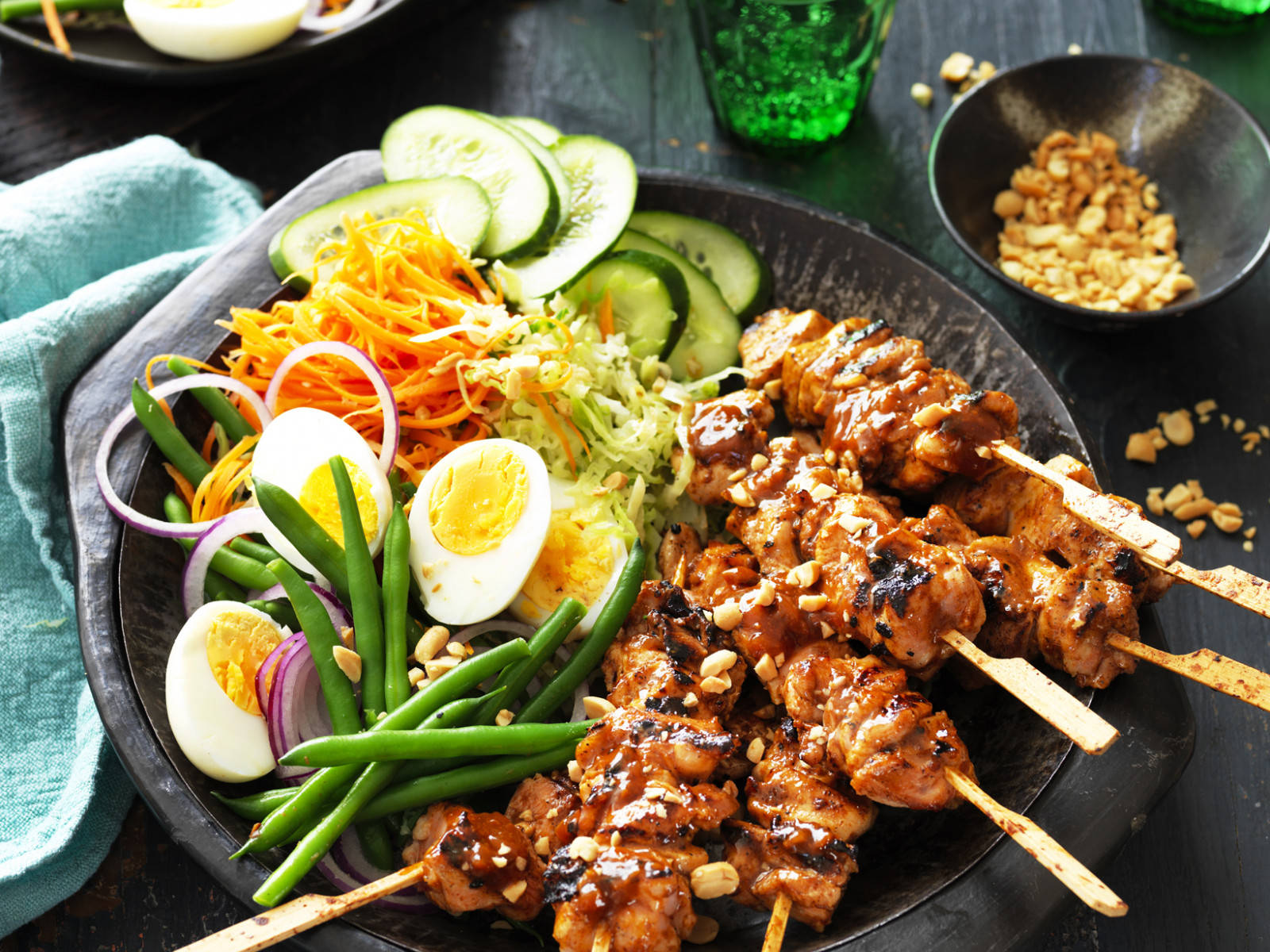 Delicious Chicken Satay with Fresh Salad and Savory Peanut Sauce Wallpaper