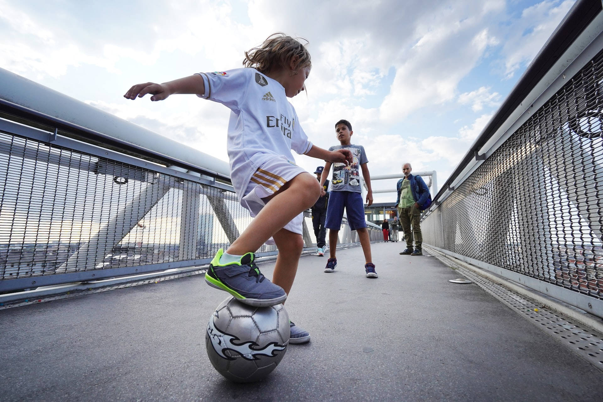 Child On A Bridge Playing Football Hd