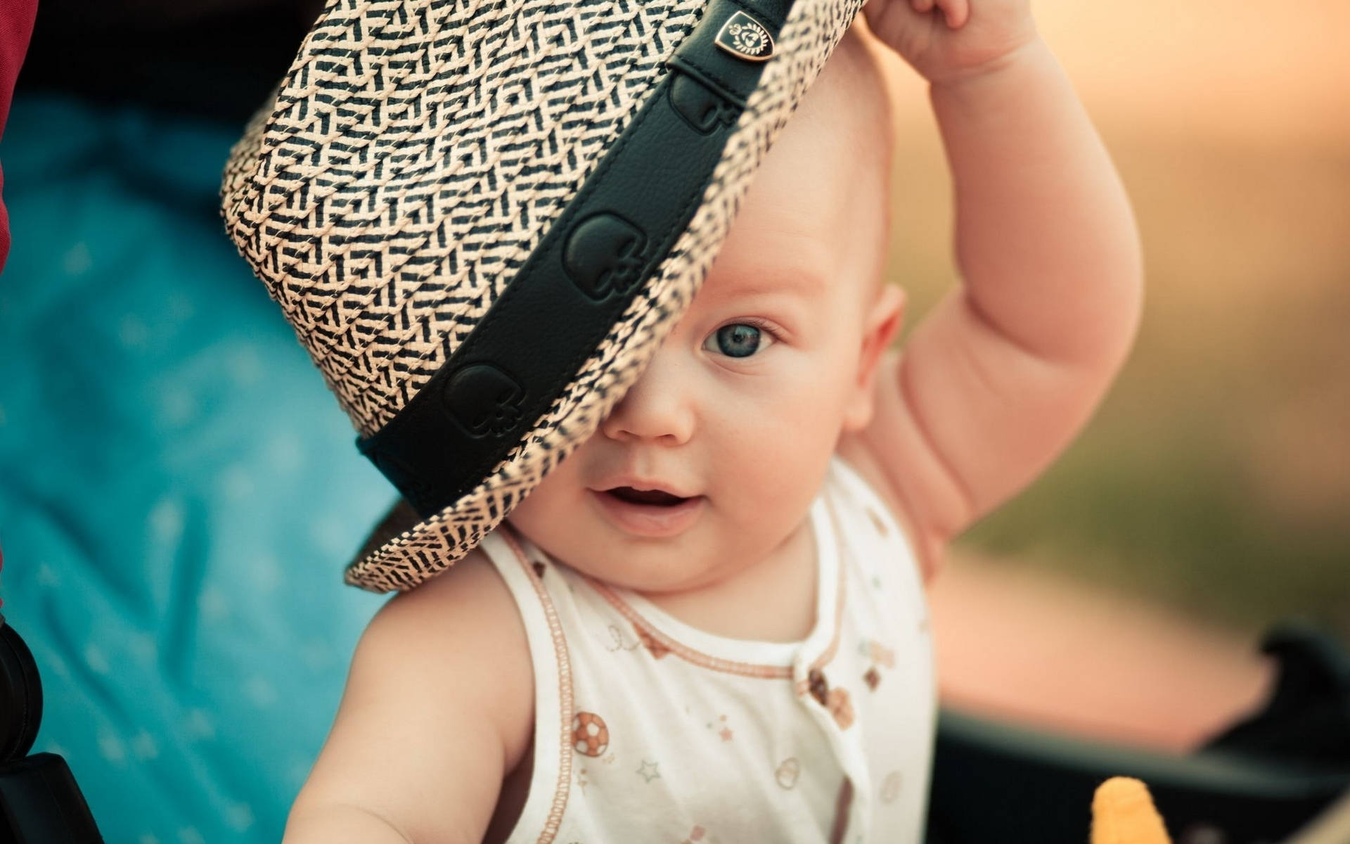 Child With Blue Eyes And Hat Wallpaper