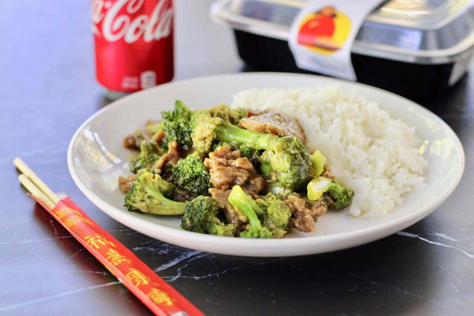 A Plate With Broccoli, Rice And Coke