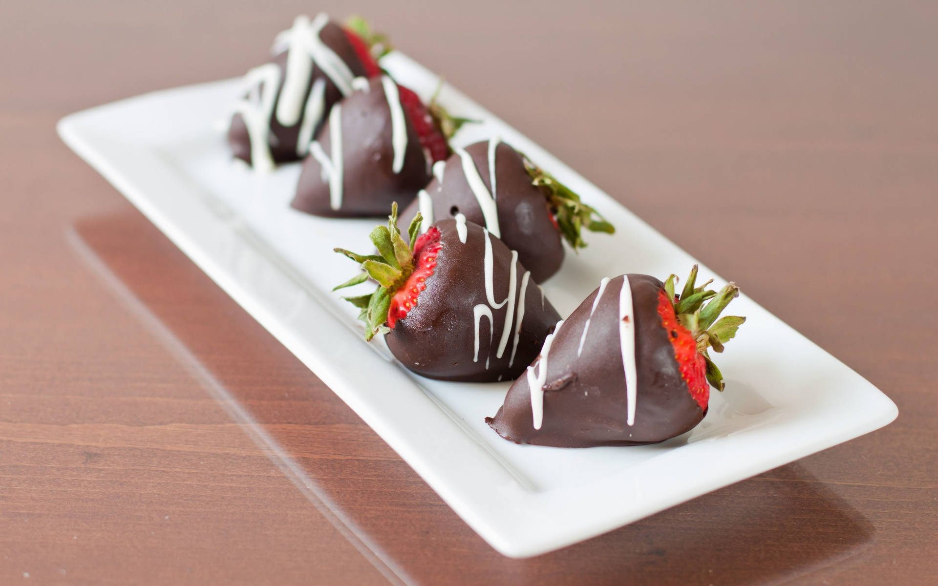 Caption: Delightful Chocolate Dipped Strawberries Wallpaper