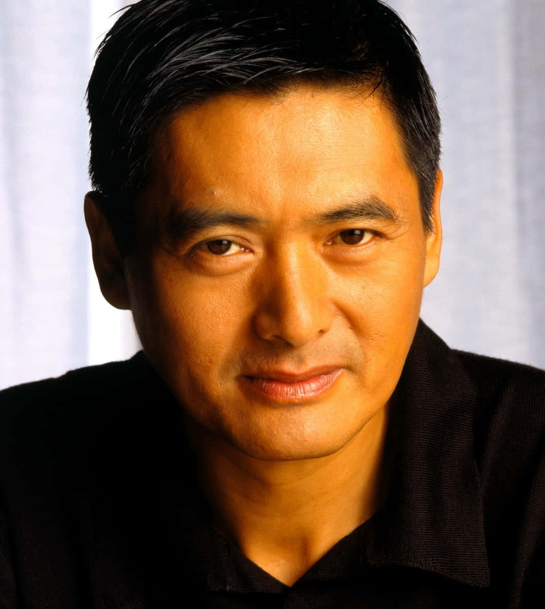 Distinguished Hong Kong actor Chow Yun-fat in a contemplative pose. Wallpaper