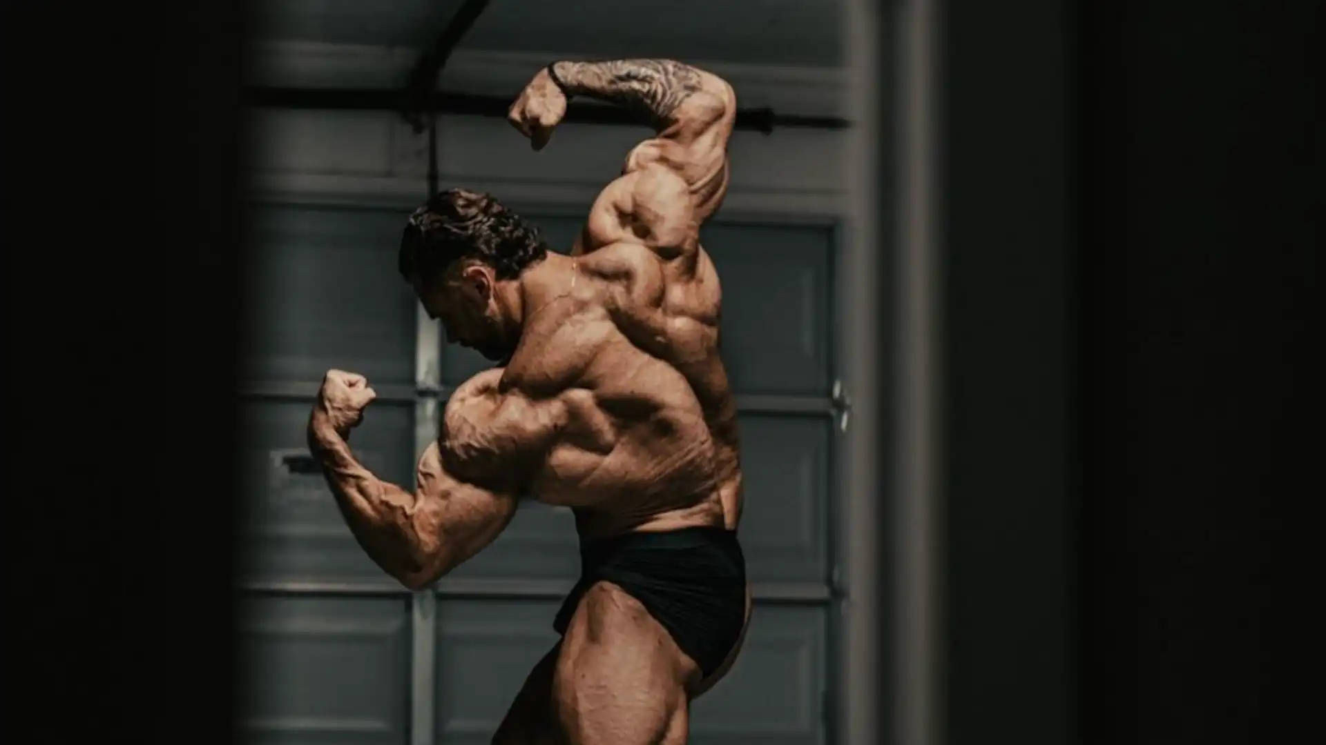Chris Bumstead Flexing Back Muscles Wallpaper