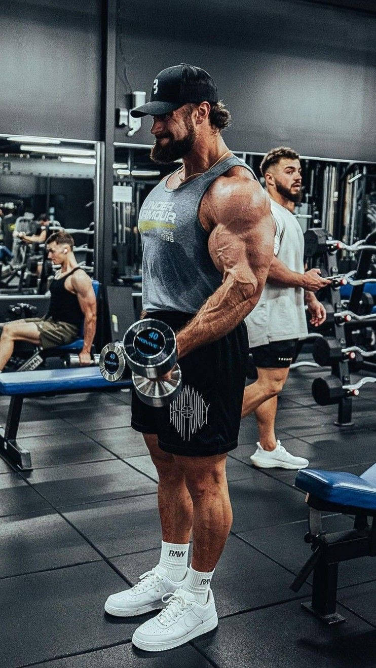 Chris Bumstead Side Profile With Dumbbells Wallpaper