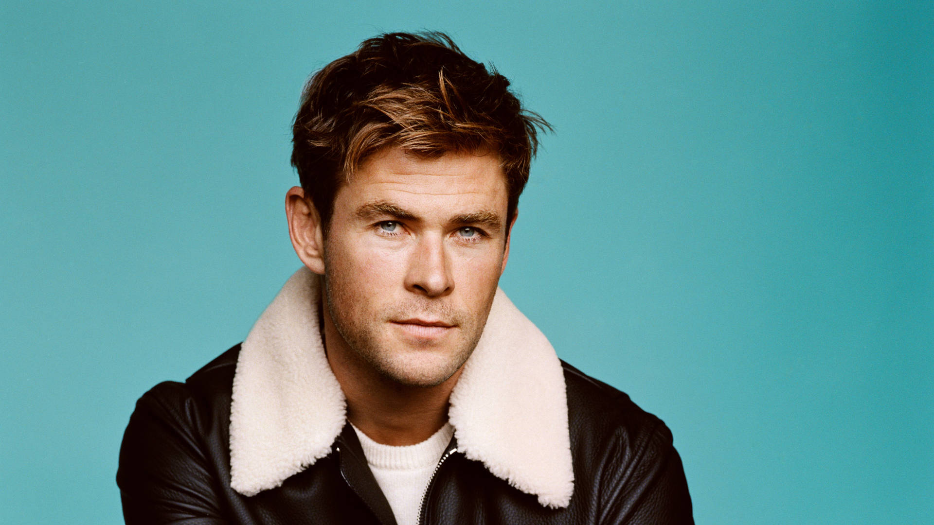 Chris Hemsworth looks dapper in a fur and leather jacket. Wallpaper