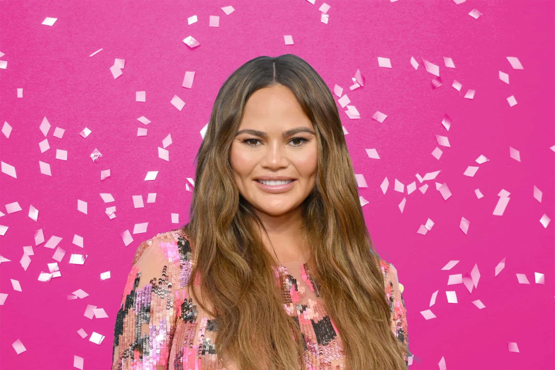 Chrissy Teigen Pink Backdrop Confetti Wallpaper