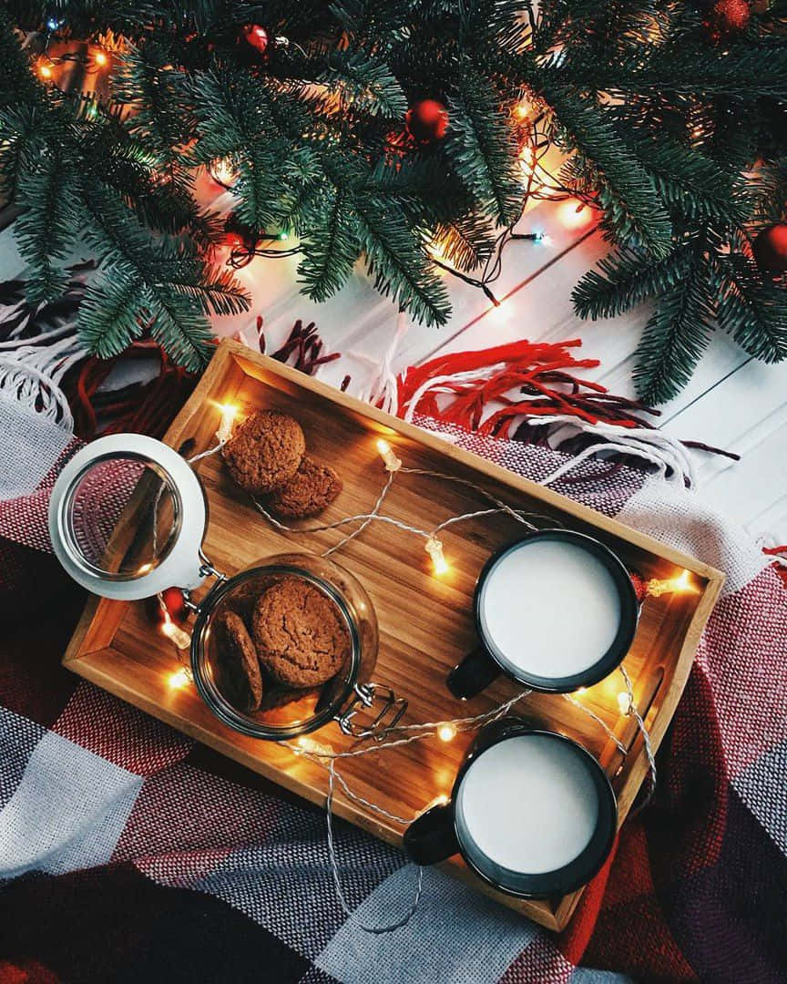 A Tray With Cookies And Milk On It Next To A Christmas Tree