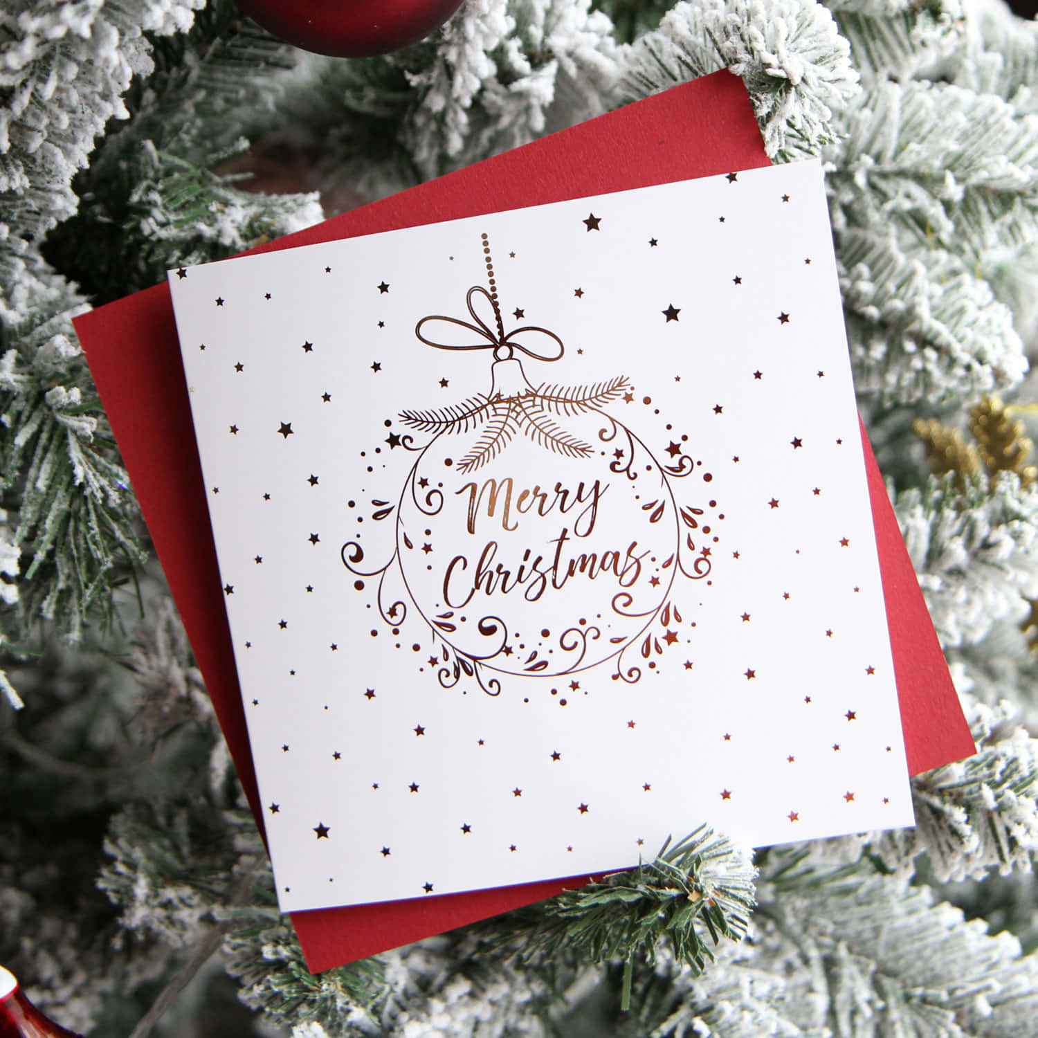 A Christmas Card With A Red And White Ornament