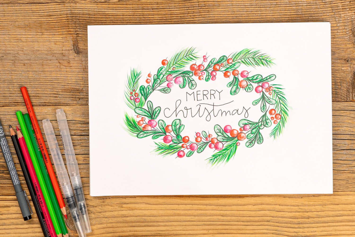 A Christmas Card With A Wreath Of Holly And Berries