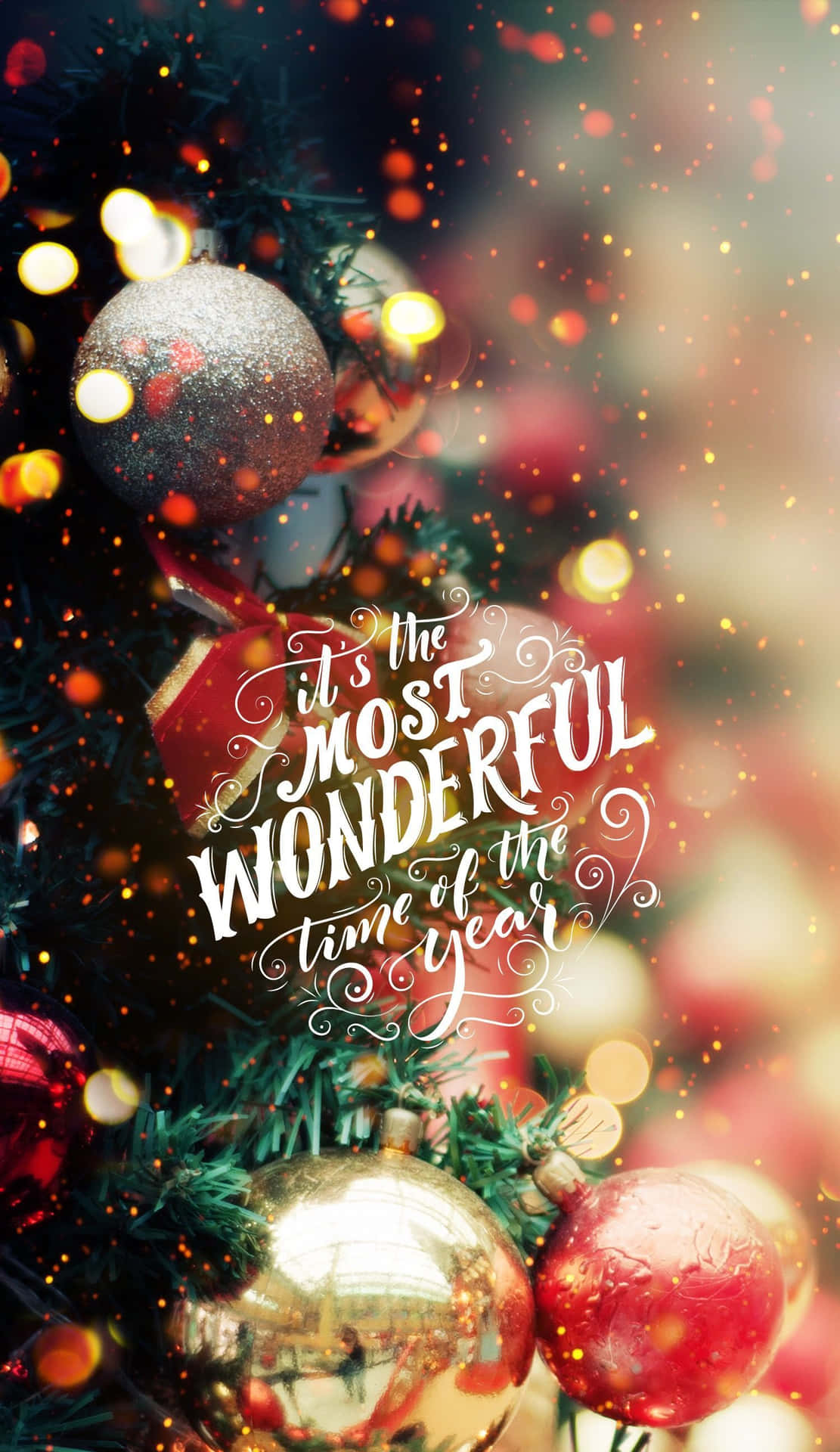 A Christmas Tree With A Quote That Says'it's The Most Wonderful Time Of The Year' Wallpaper