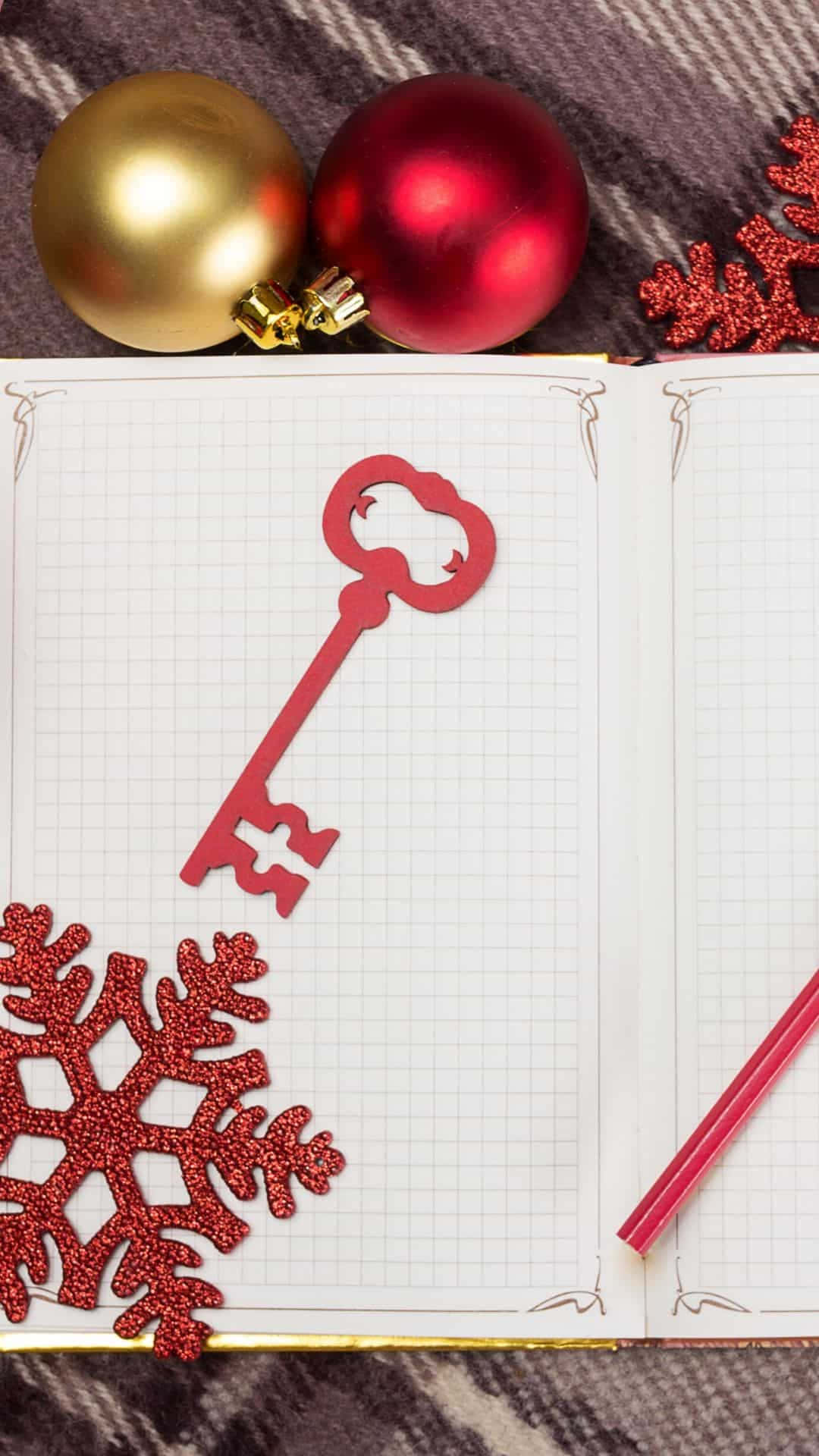 a notebook with a key and snowflakes on it