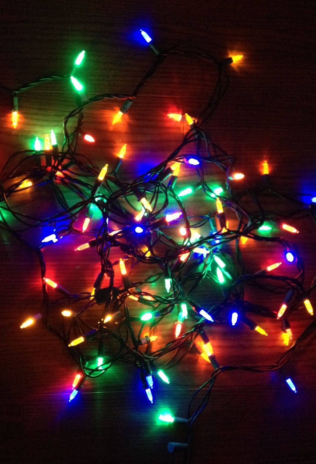 Christmas Lights On A Wooden Table Wallpaper