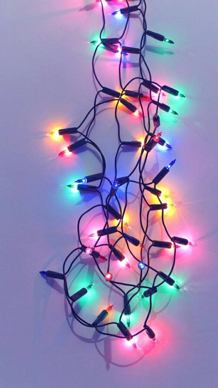 "Make Your Holiday Sparkle With Christmas Lights Iphone" Wallpaper