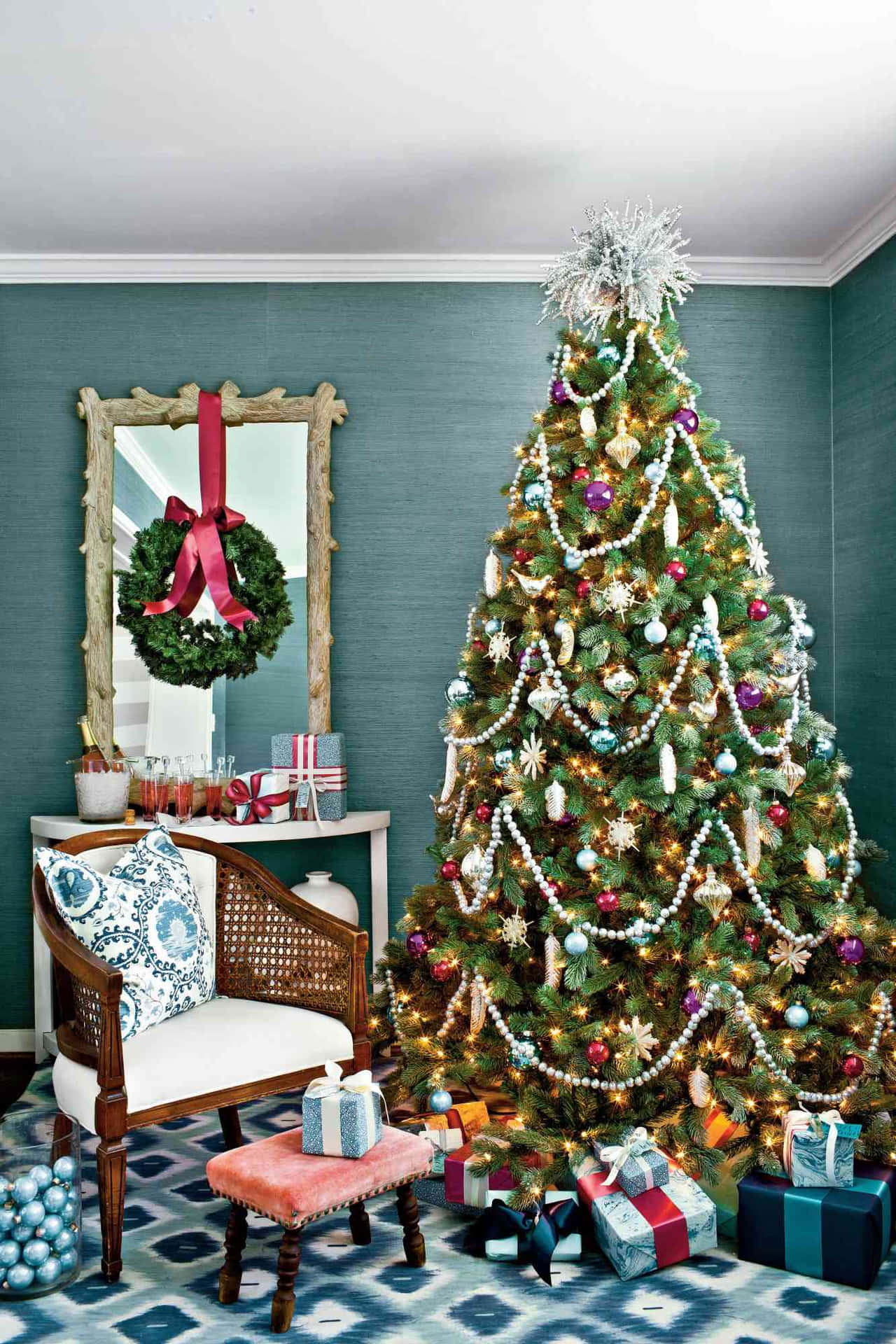 A Christmas Tree In A Room With Blue And White Decorations
