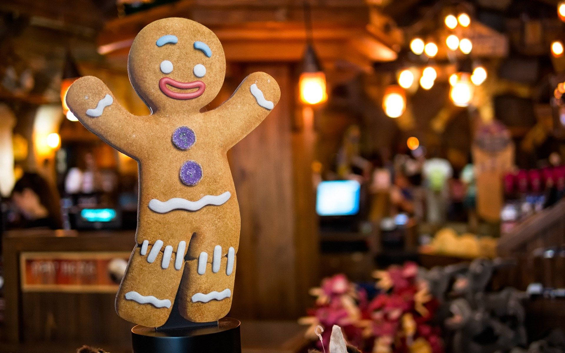 A Gingerbread Man Is Sitting On A Table Wallpaper