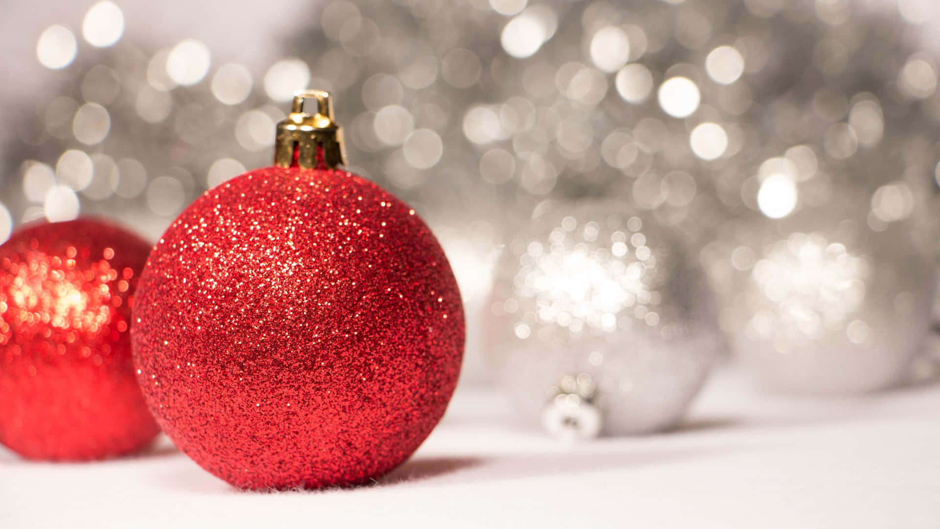 Christmas Ornaments On A White Background With Silver And Red Lights Wallpaper