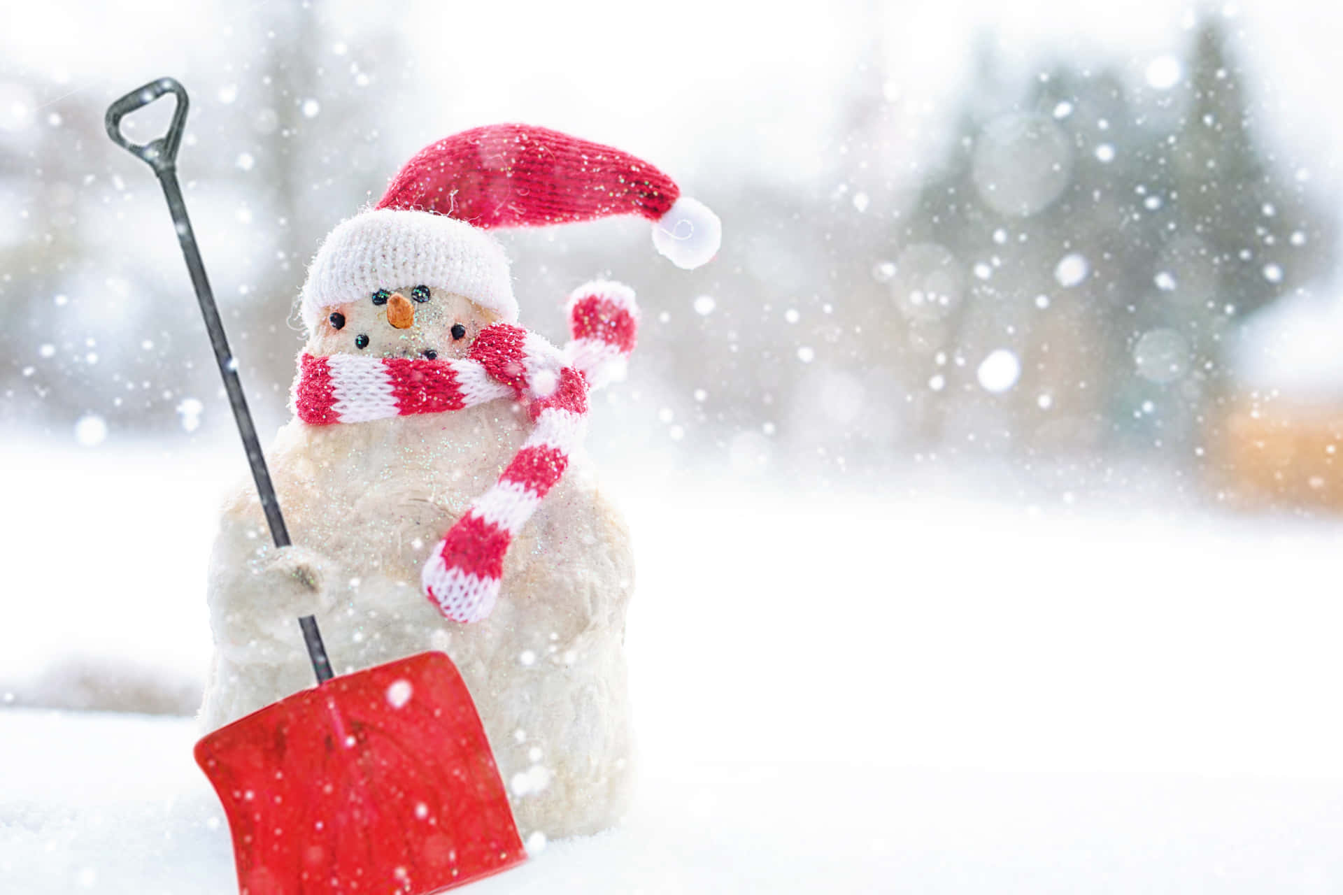 Enjoy a peaceful winter landscape of soft snow and festive Christmas lights Wallpaper