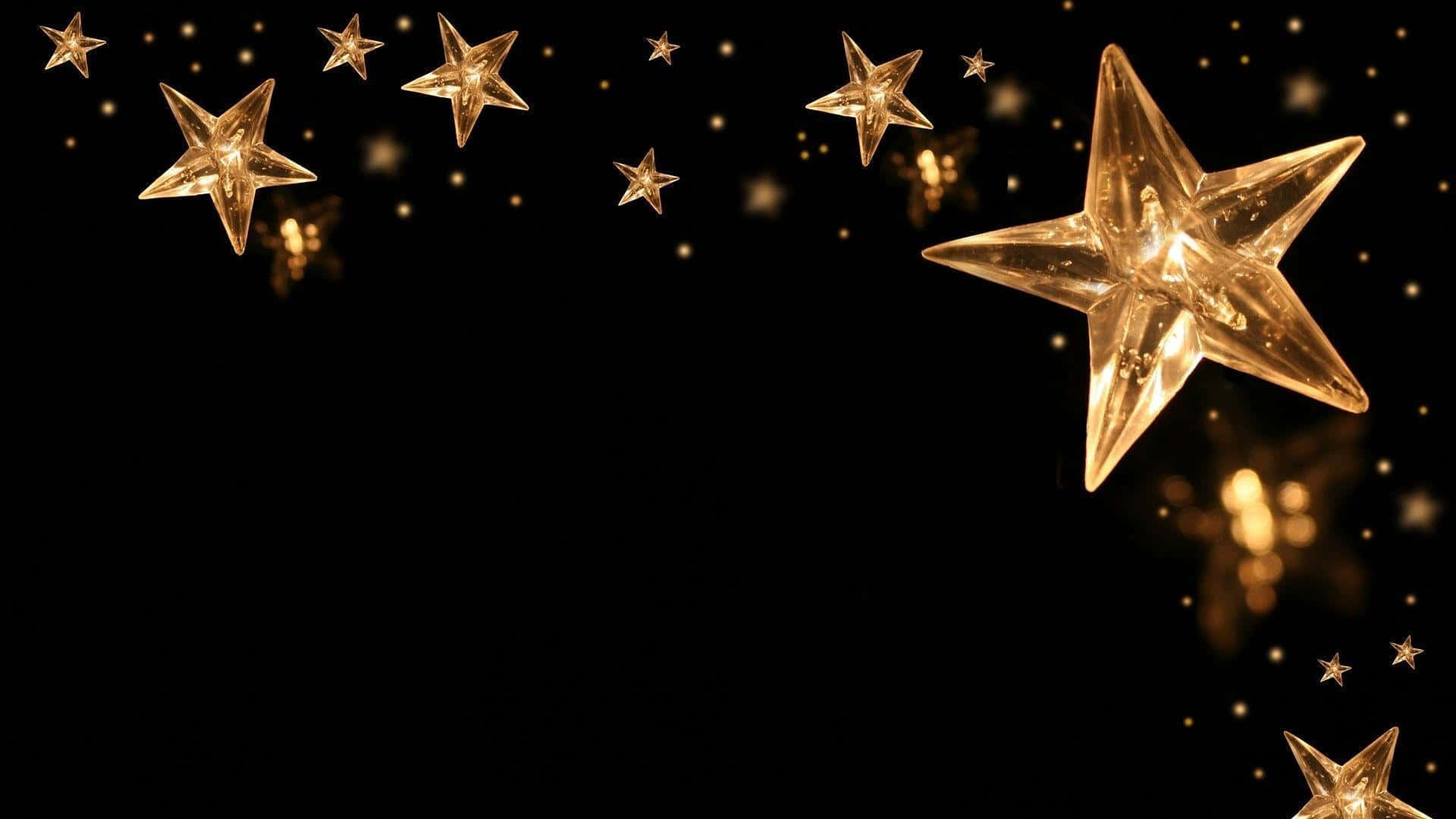 A Black Background With Gold Stars On It Wallpaper