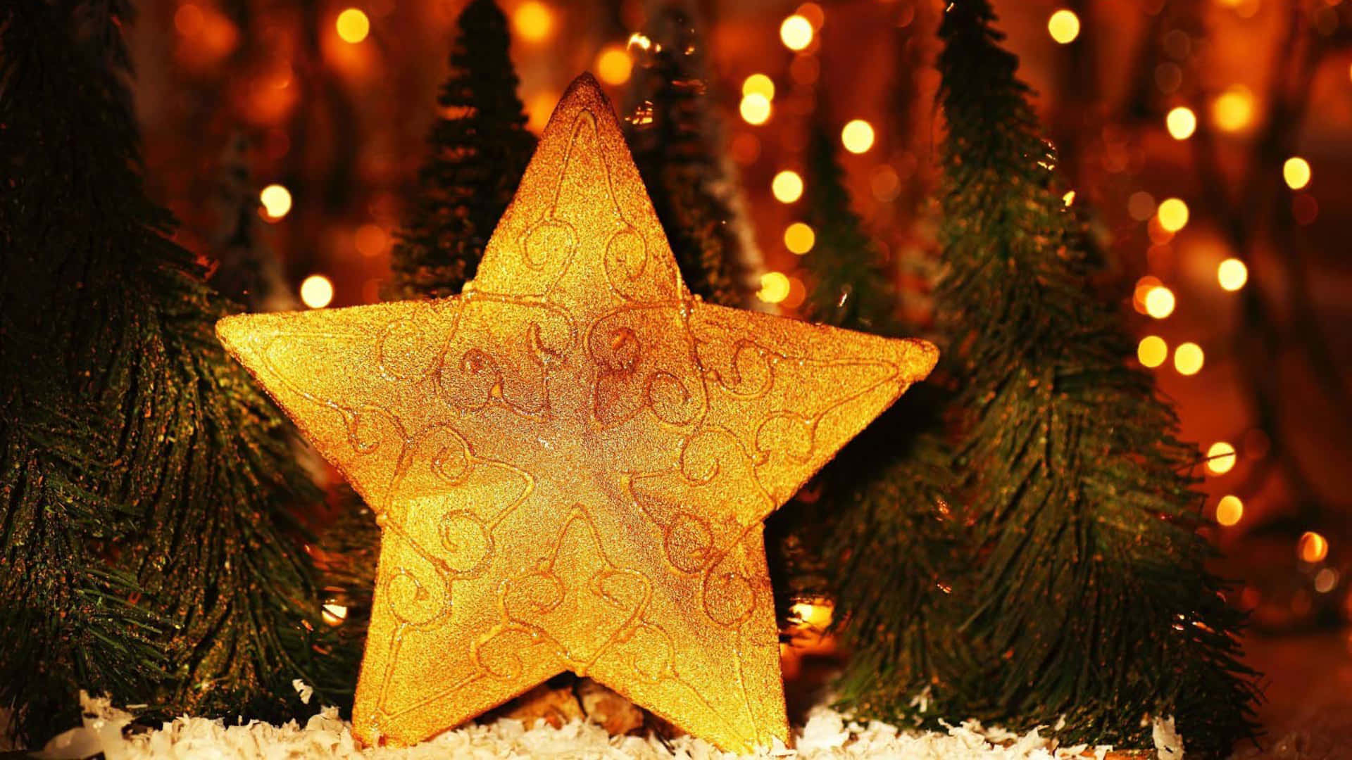 An illuminated Christmas star overlooking a sleepy winter town. Wallpaper