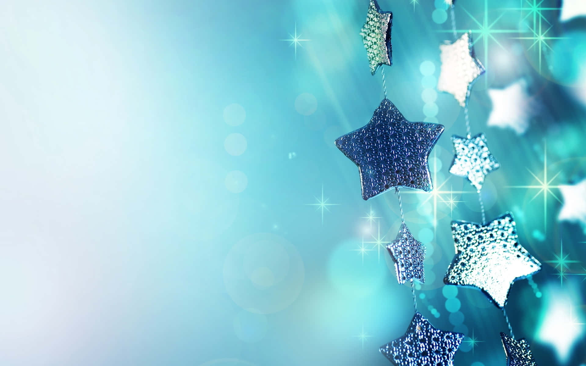 An illuminated star glows atop a Christmas tree Wallpaper