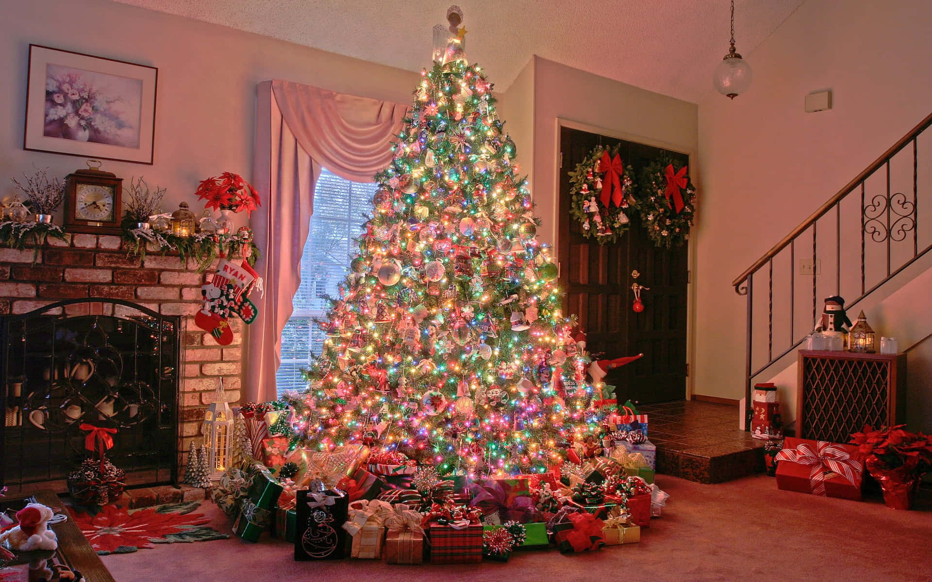 Brightly lit Christmas tree with presents around it.