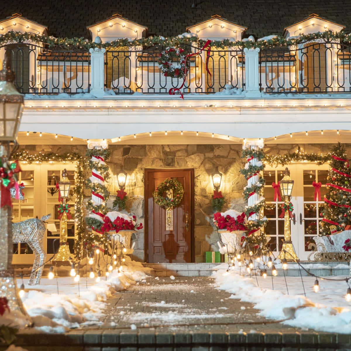 A House With Christmas Lights And Decorations On The Front Porch