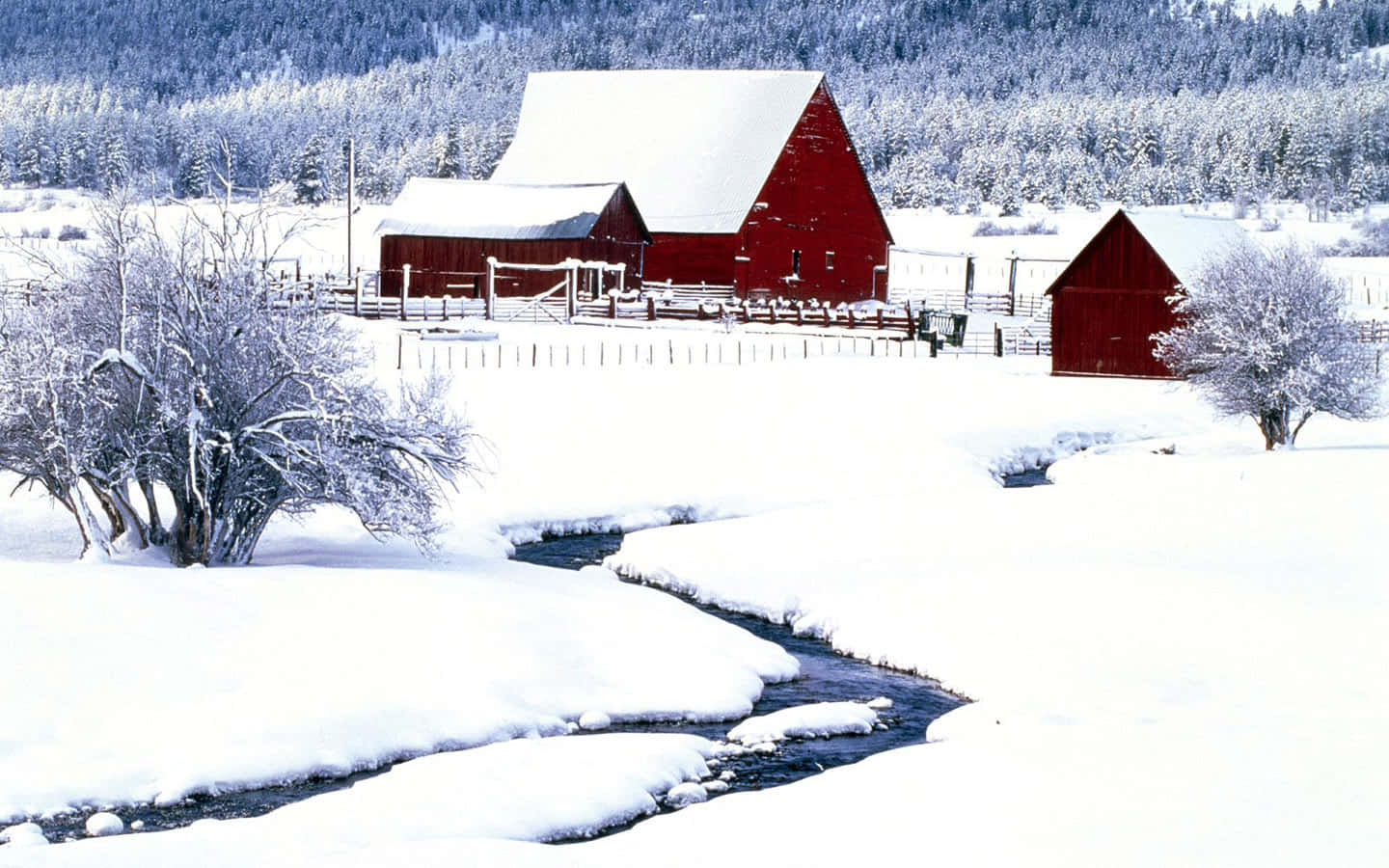 A Red Barn In The Snow With A Stream Wallpaper