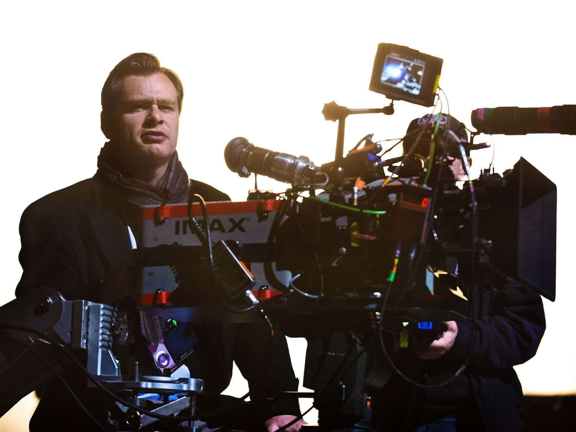 Christopher Nolan standing on set in an intense moment Wallpaper