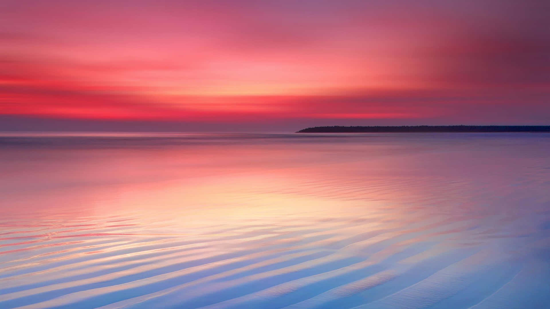 A Sunset With A Pink Sky And Water Wallpaper
