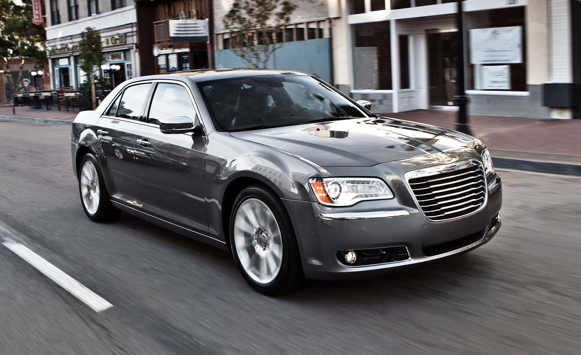 Sleek Black Chrysler 300 Cruising on the Highway Wallpaper