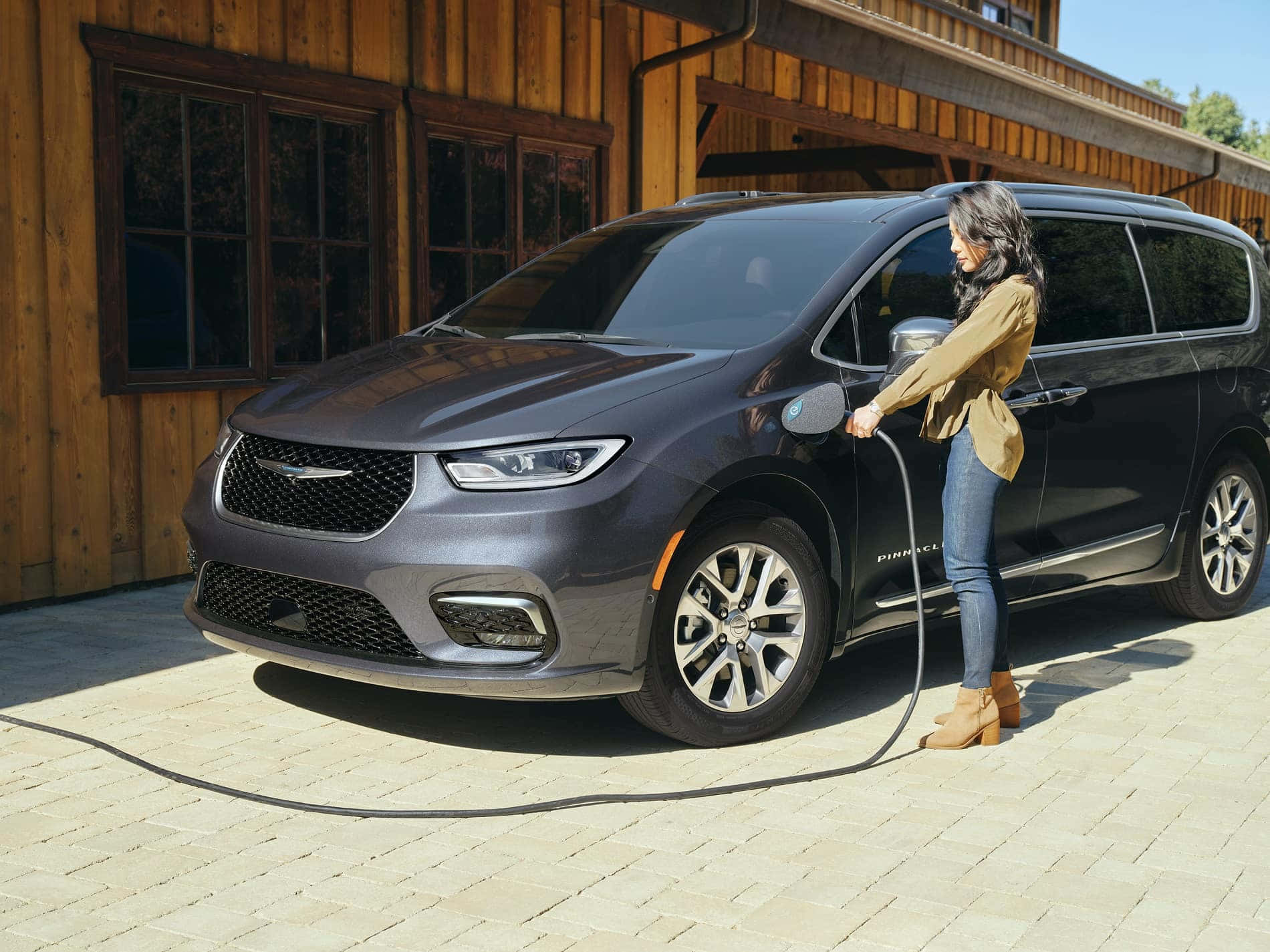 A Woman Is Charging Her New Chrysler Pacifica