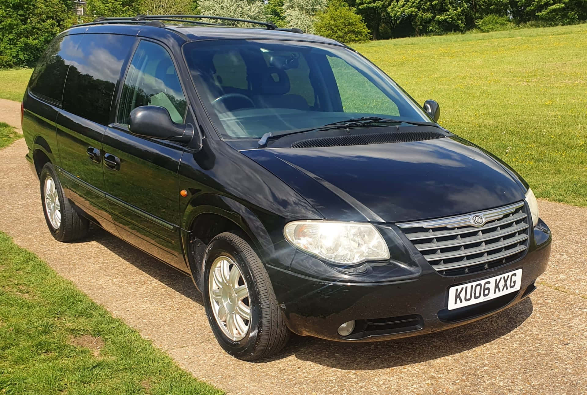 Sleek Silver Chrysler Voyager on the Road Wallpaper