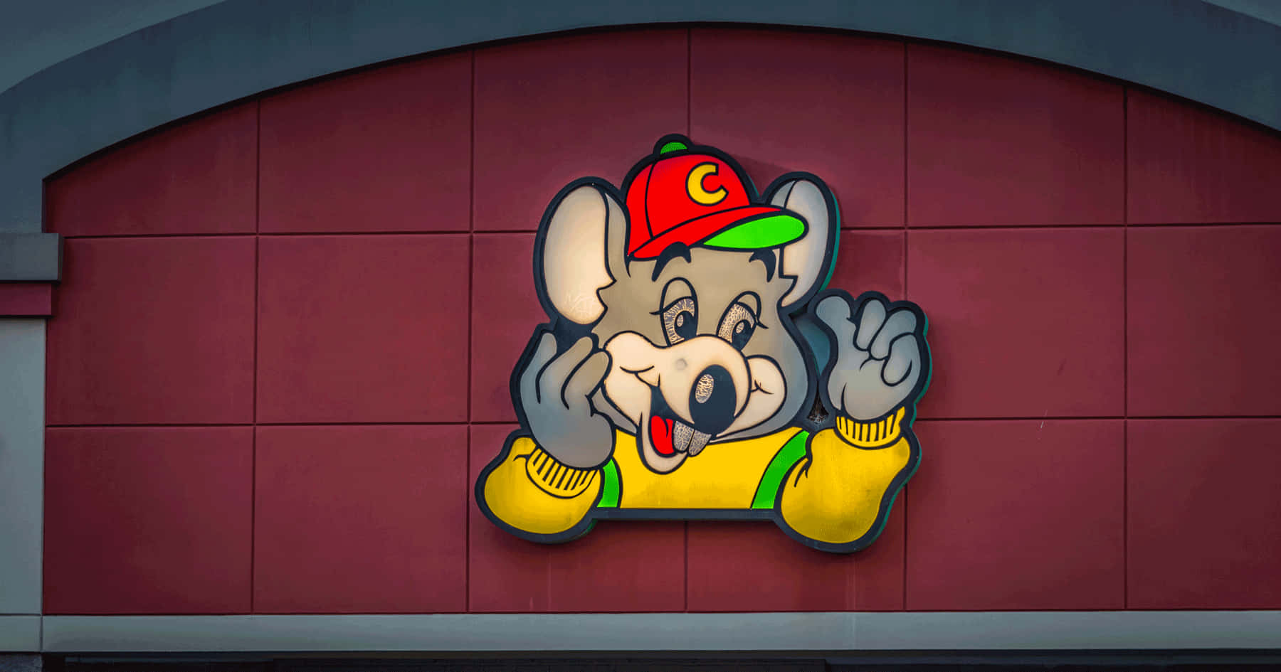 A Cartoon Mouse Is On The Side Of A Building