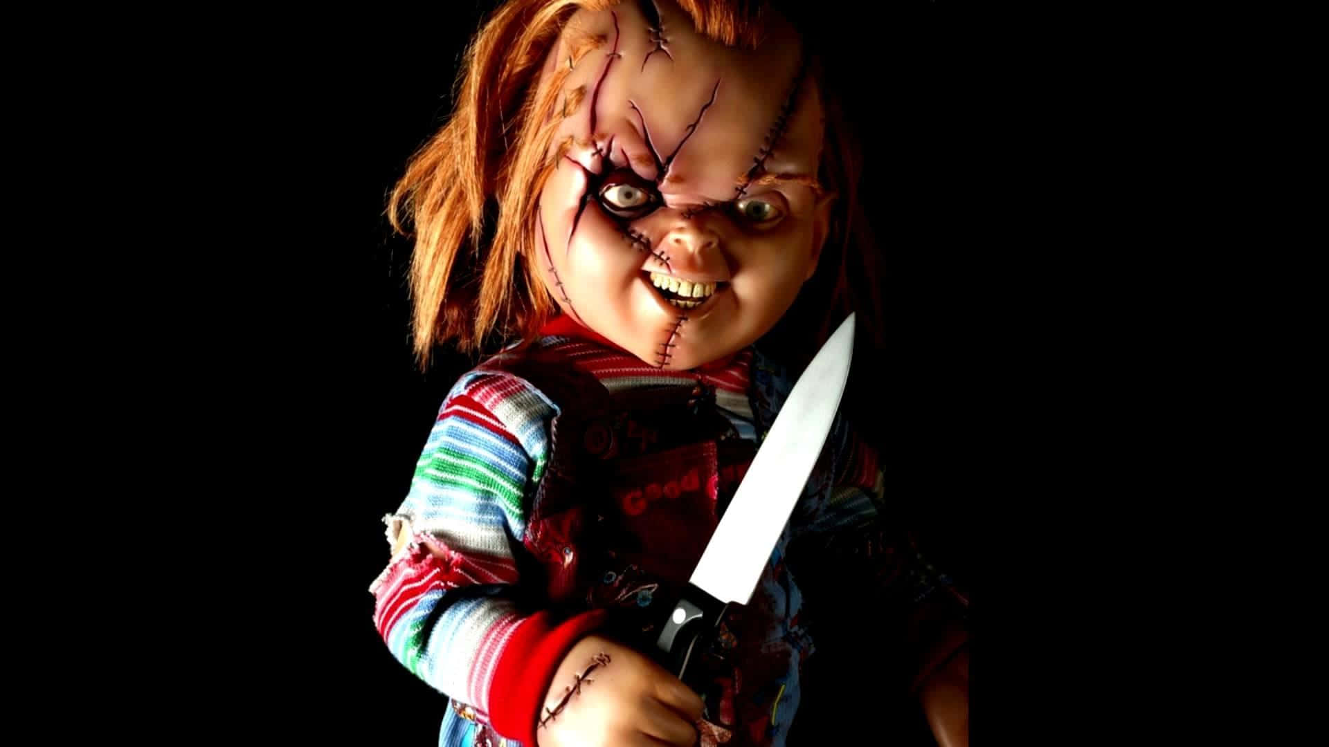 A terrifying scene with a Chucky Doll looking straight at the camera. Wallpaper