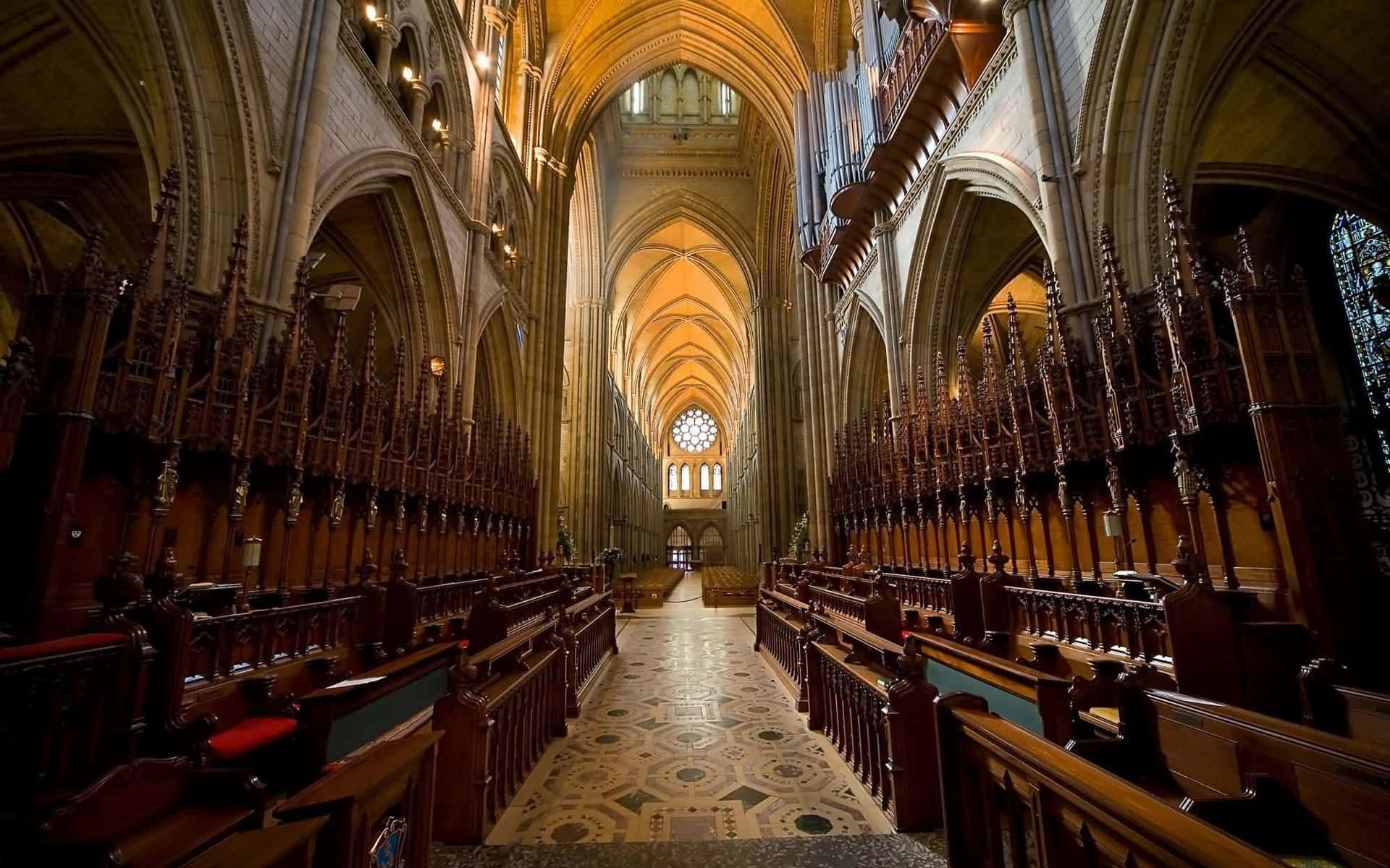 The Inside Of A Cathedral With Wooden Pews