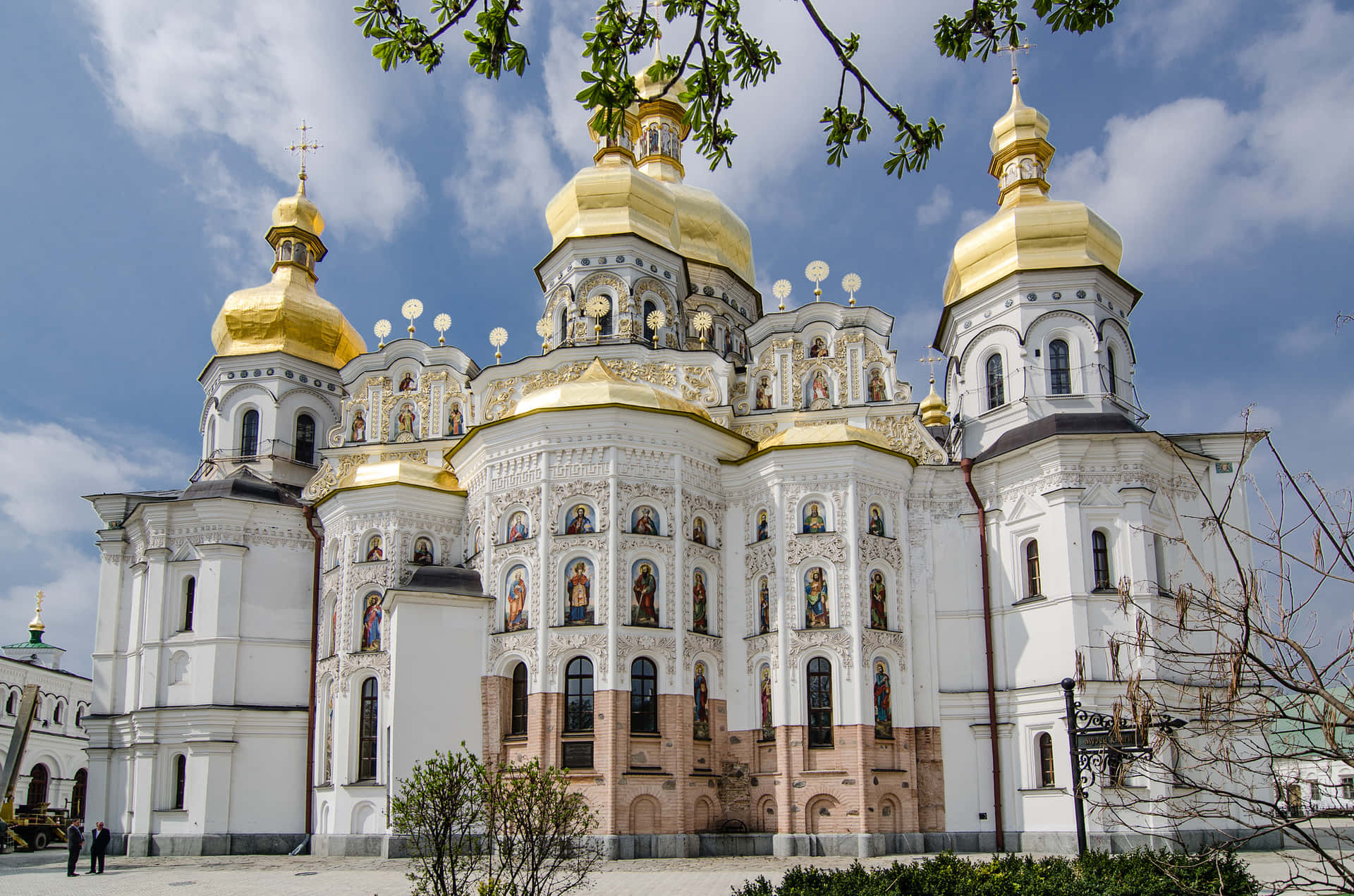 A White Building With Gold Domes