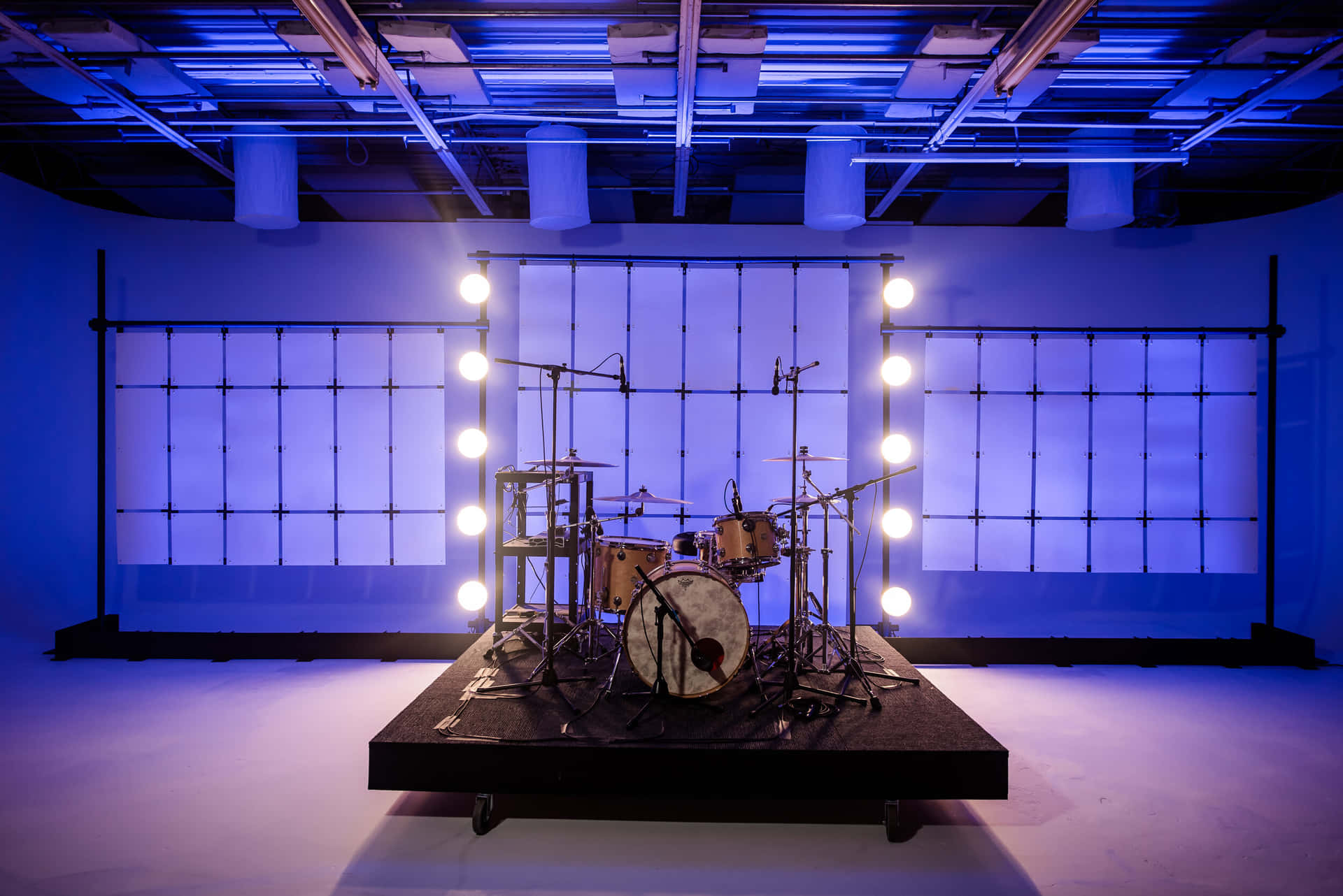 A Drum Set Is On A Stage With Blue Lights