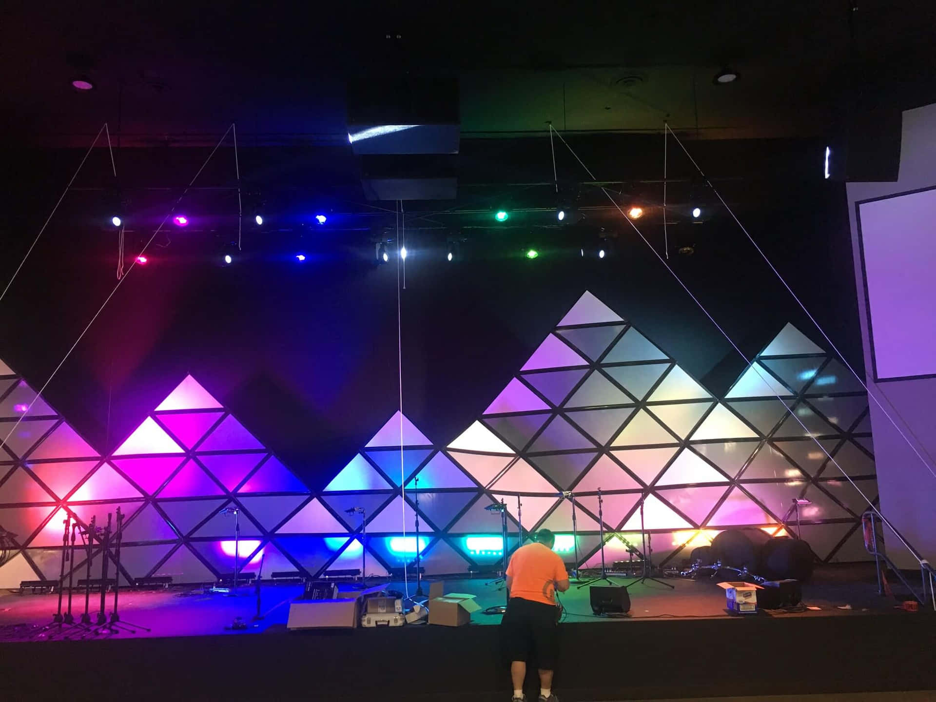 A Stage With Colorful Lights And A Stage With A Triangle