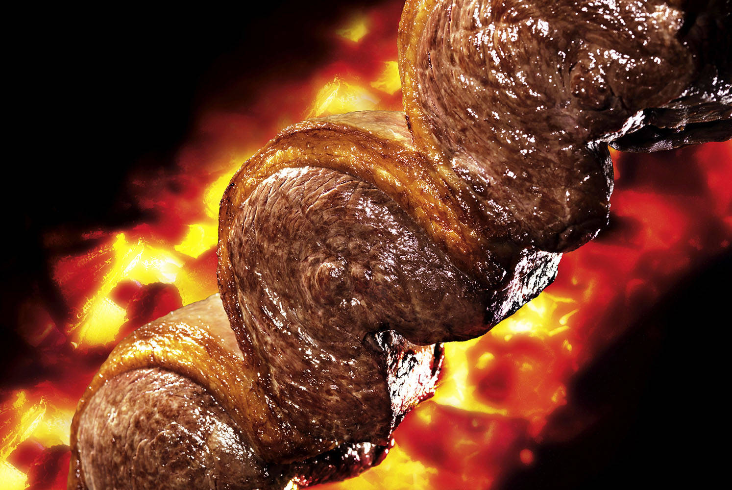 A delightful close-up view of Churrasco grilling Wallpaper