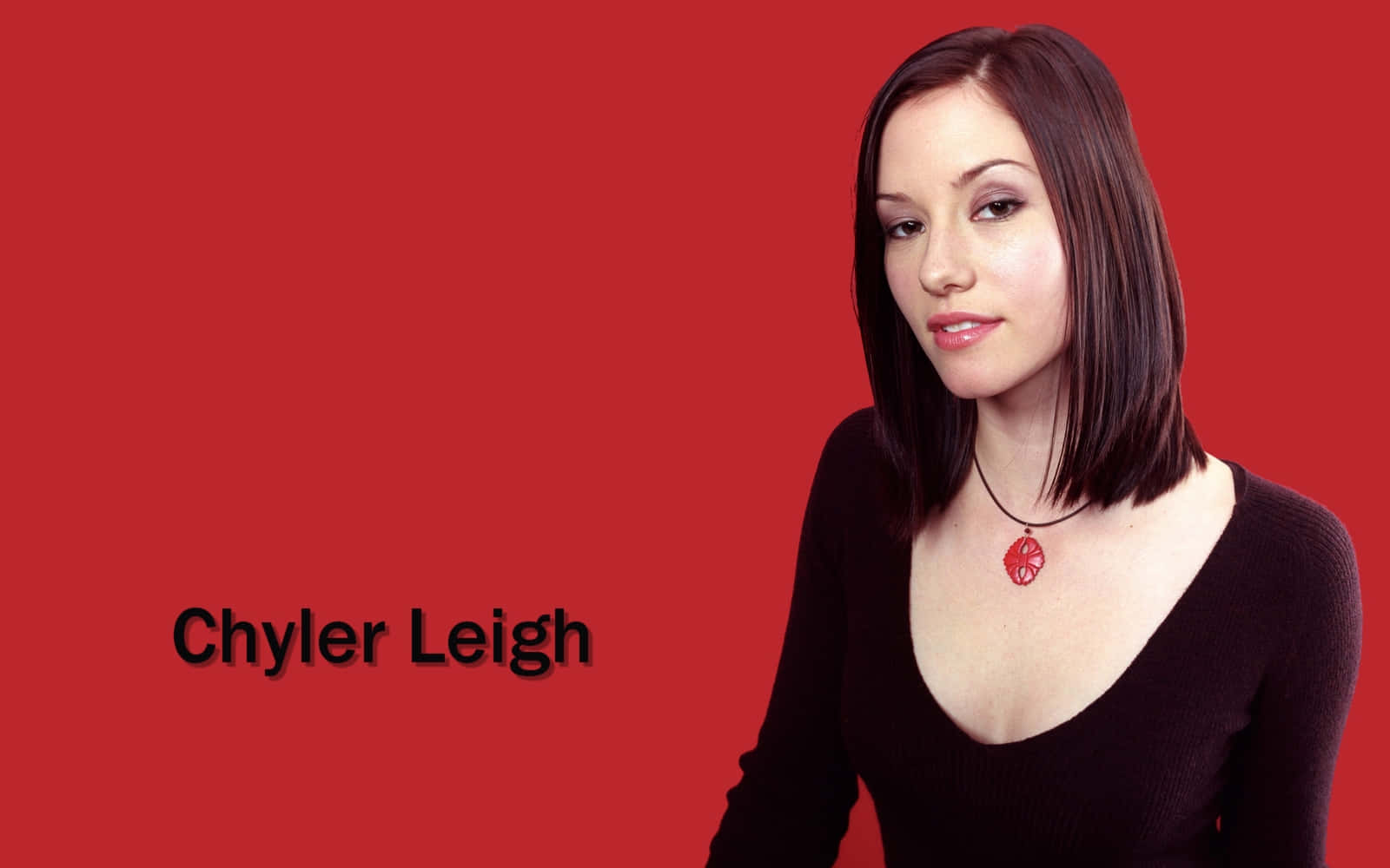 Chyler Leigh posing in an elegant red dress Wallpaper