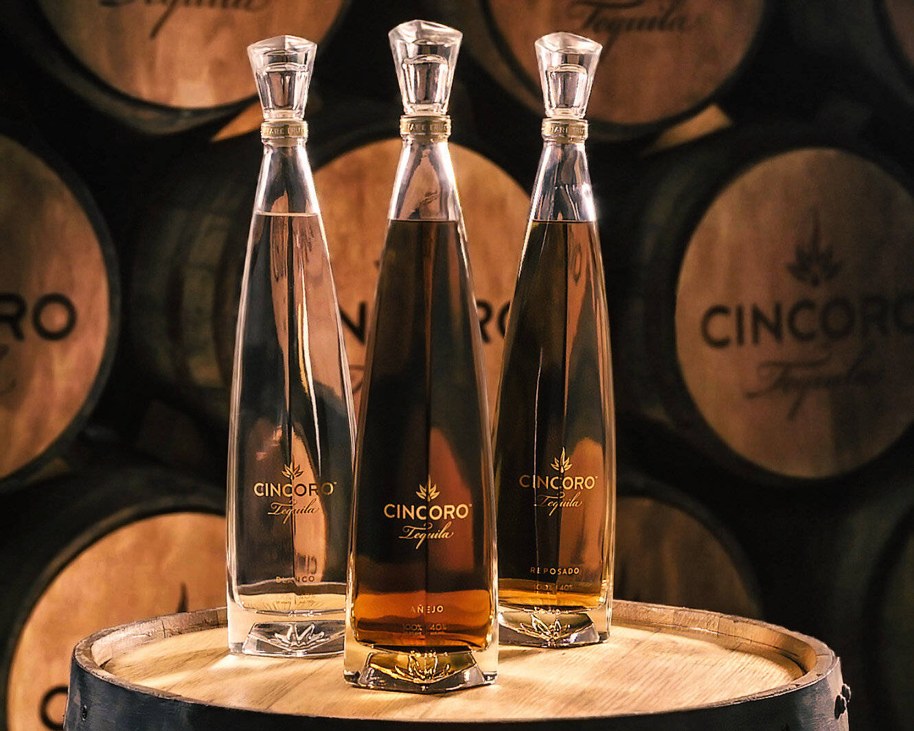 A Luxurious Experience - Cincoro Tequila Bottle presented on a Wooden Cask Wallpaper
