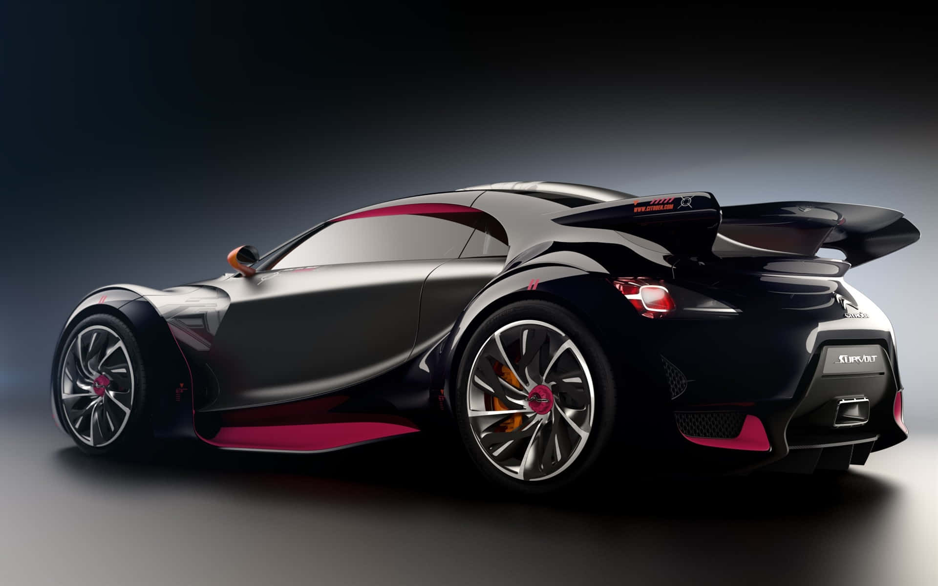 A Black And Pink Sports Car Is Shown In A Dark Room