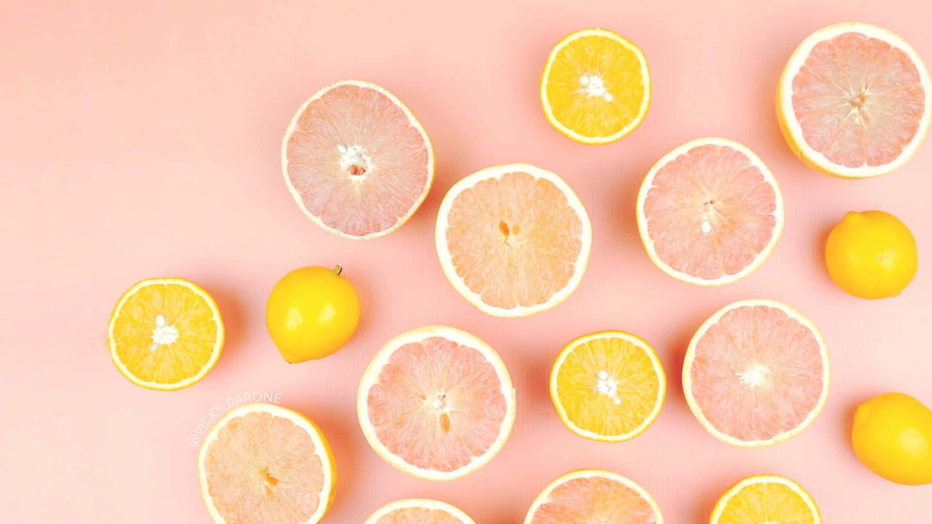 Citrus Fruit Assortment Pink Background Wallpaper