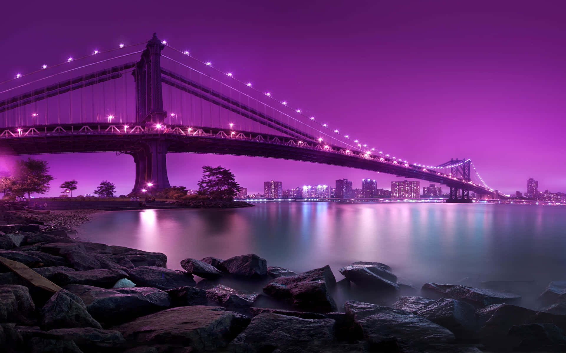 Purple Lights And Rocks On The Water Wallpaper