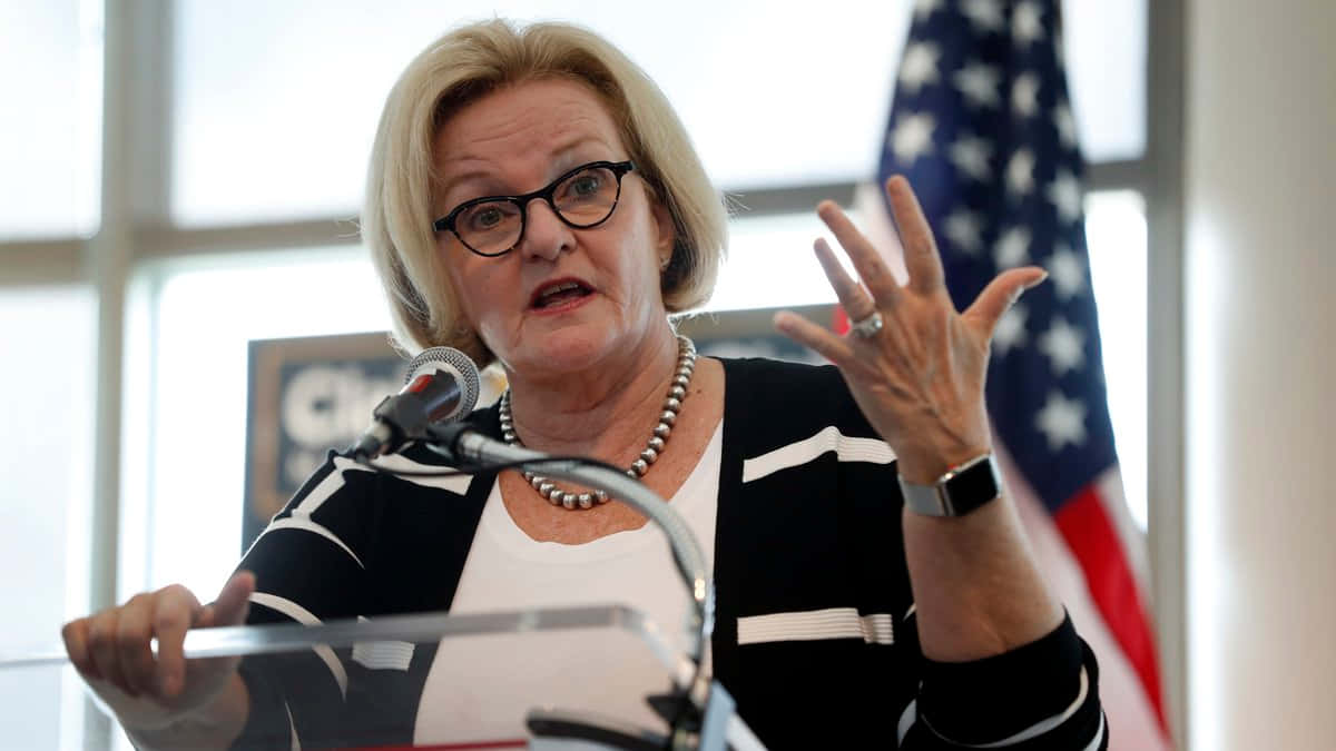 Claire Mccaskill Gesturing With Us Flag Background