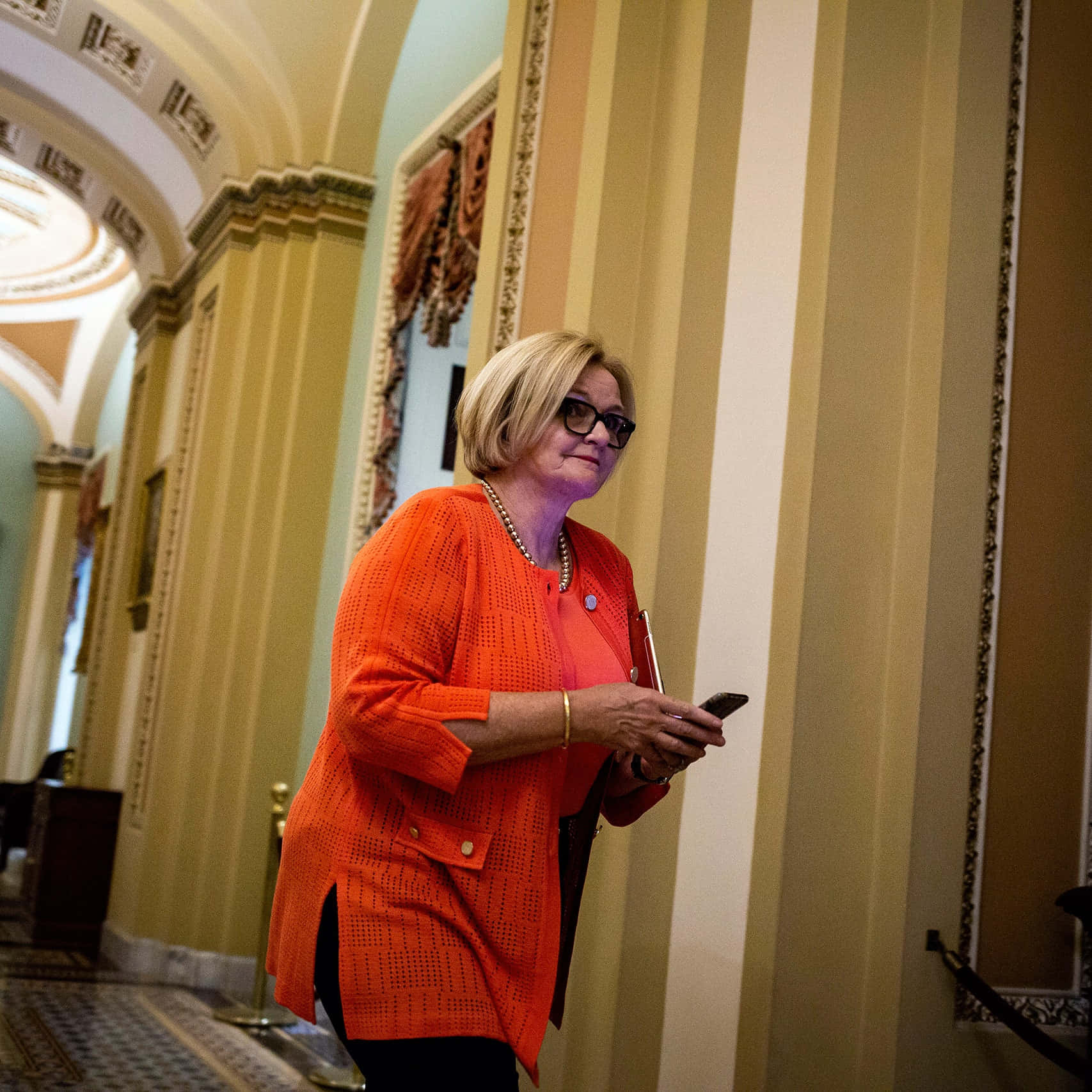 Claire Mccaskill Walking Through Capitol Hill Background