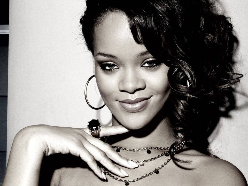 Singer Rihanna shows off her playful attitude in this classic black and white portrait. Wallpaper