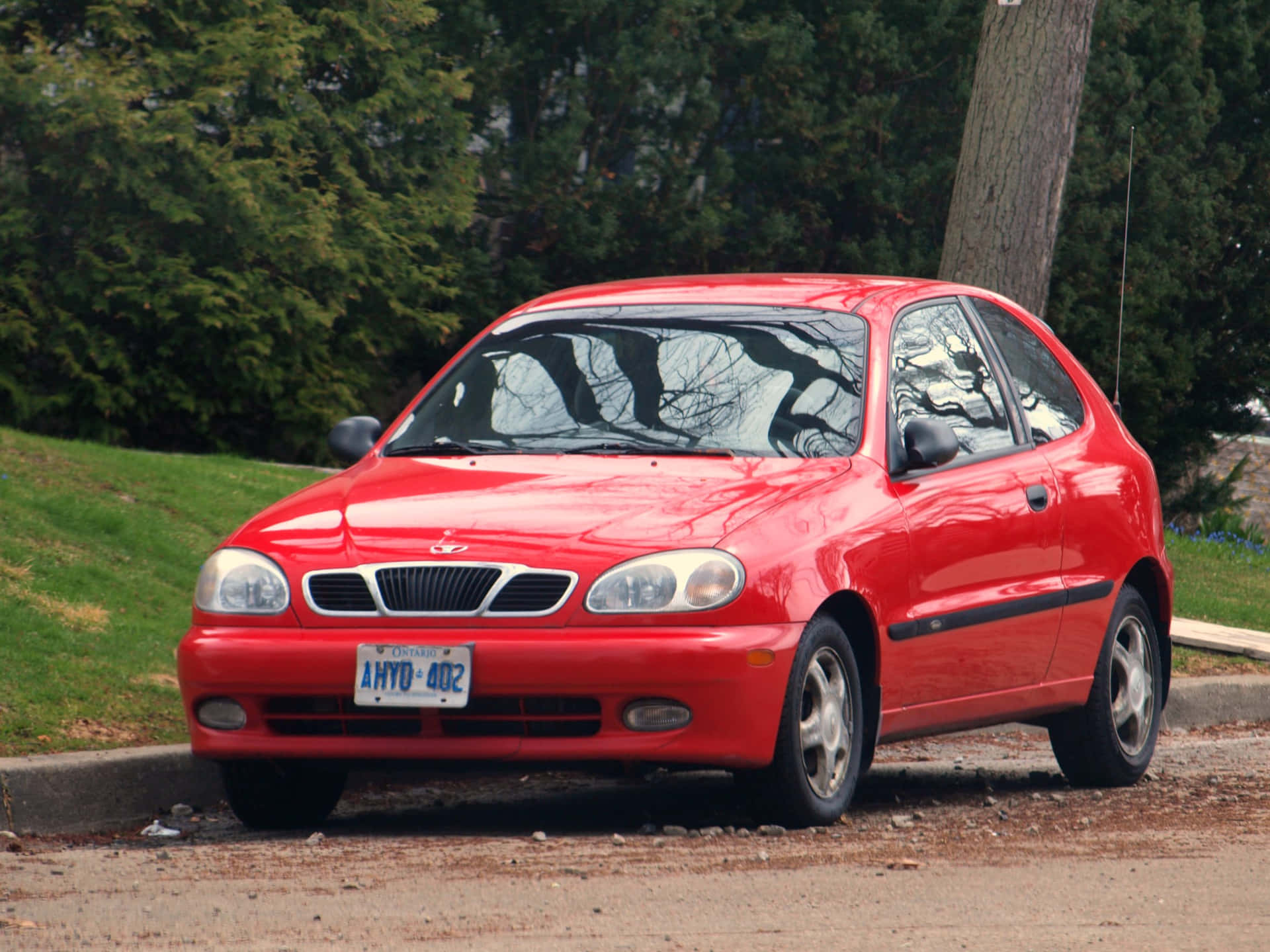 Classic Daewoo Lanos Parked On A Sunny Street Wallpaper